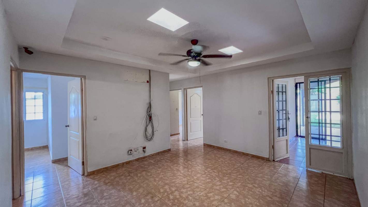 Living room with multiple doors, tiled floors, ceiling fans in Villa Zaita House Las Cumbres