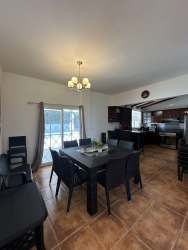 Contemporary dining area open to kitchen with sliding glass door Playa Blanca Panama