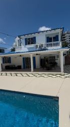 Modern outdoor pool with patio, tropical landscaping, privacy wall Playa Blanca Panama