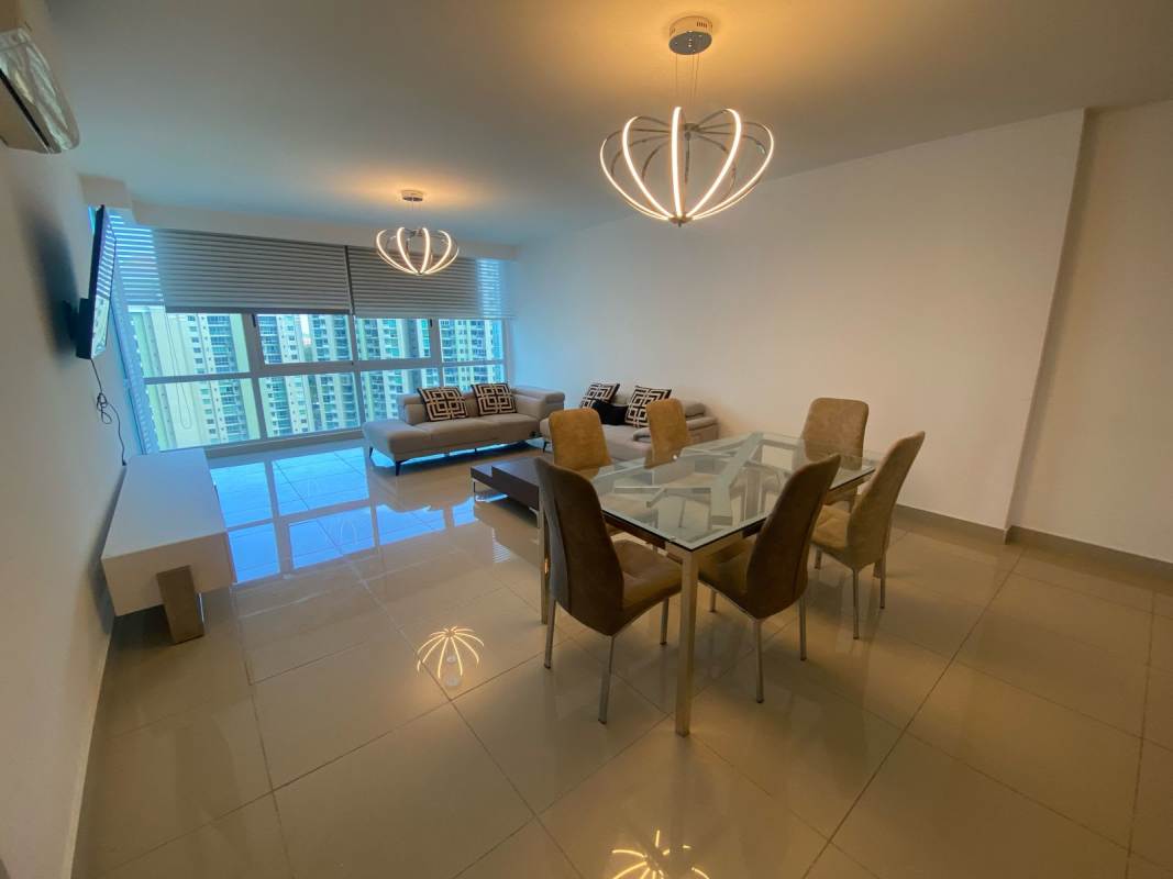 Living and dining room with glass dining table, large windows, and city views PH Top Tower Panama