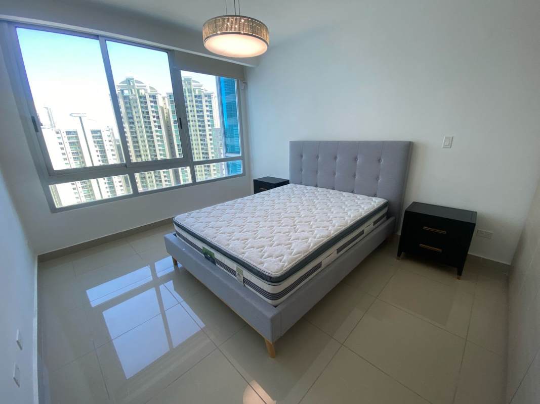 Bedroom with large window, ceramic tiles, and skyline view at PH Top Tower Costa del Este Panama