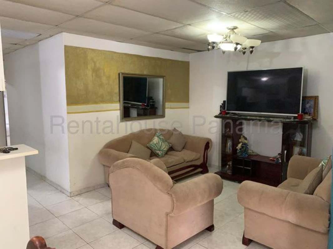 Traditional living room with beige furniture, wall mirror, tile floor in San Antonio Panama