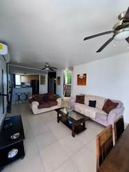 Spacious bedroom with balcony access and ocean view in Playa Blanca Resort penthouse Panama