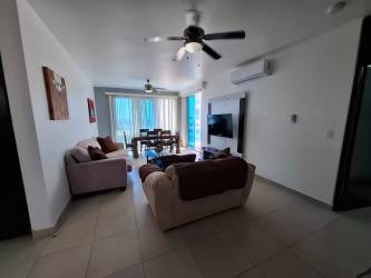 Open concept living and dining room with natural light in Playa Blanca penthouse Panama