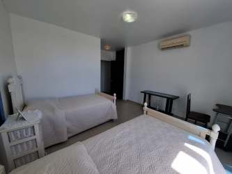 Furnished master bedroom with ocean view balcony in penthouse Playa Blanca Panama