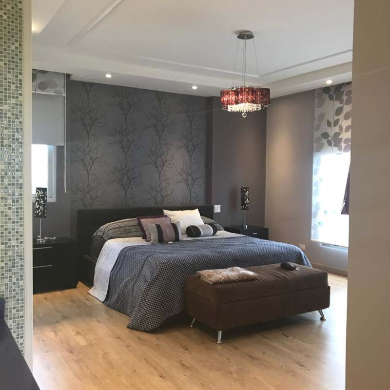 Remodeled kitchen with red cabinetry, granite counters, large windows with skyline view in PH Luxor 200 Panama