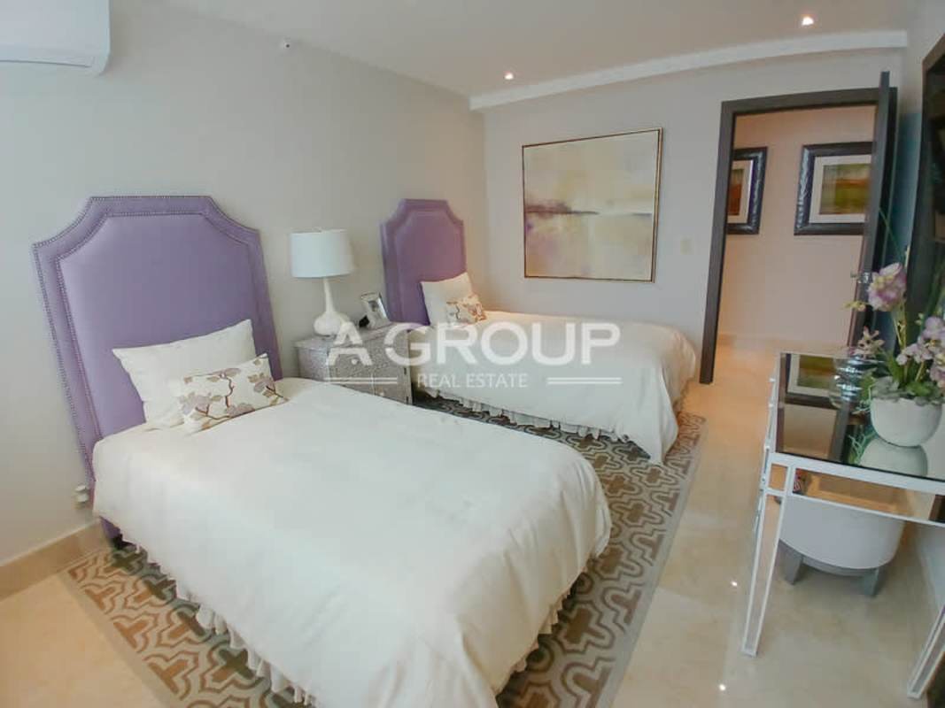 Elegant guest bedroom with purple accents and twin beds in The Colonial Santa María Panama