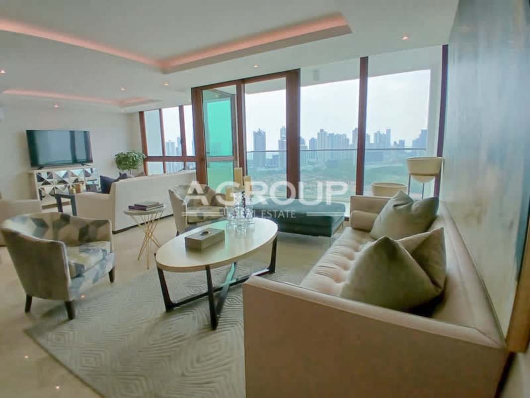 Bright living room with panoramic windows and city views in The Colonial Santa María Panama