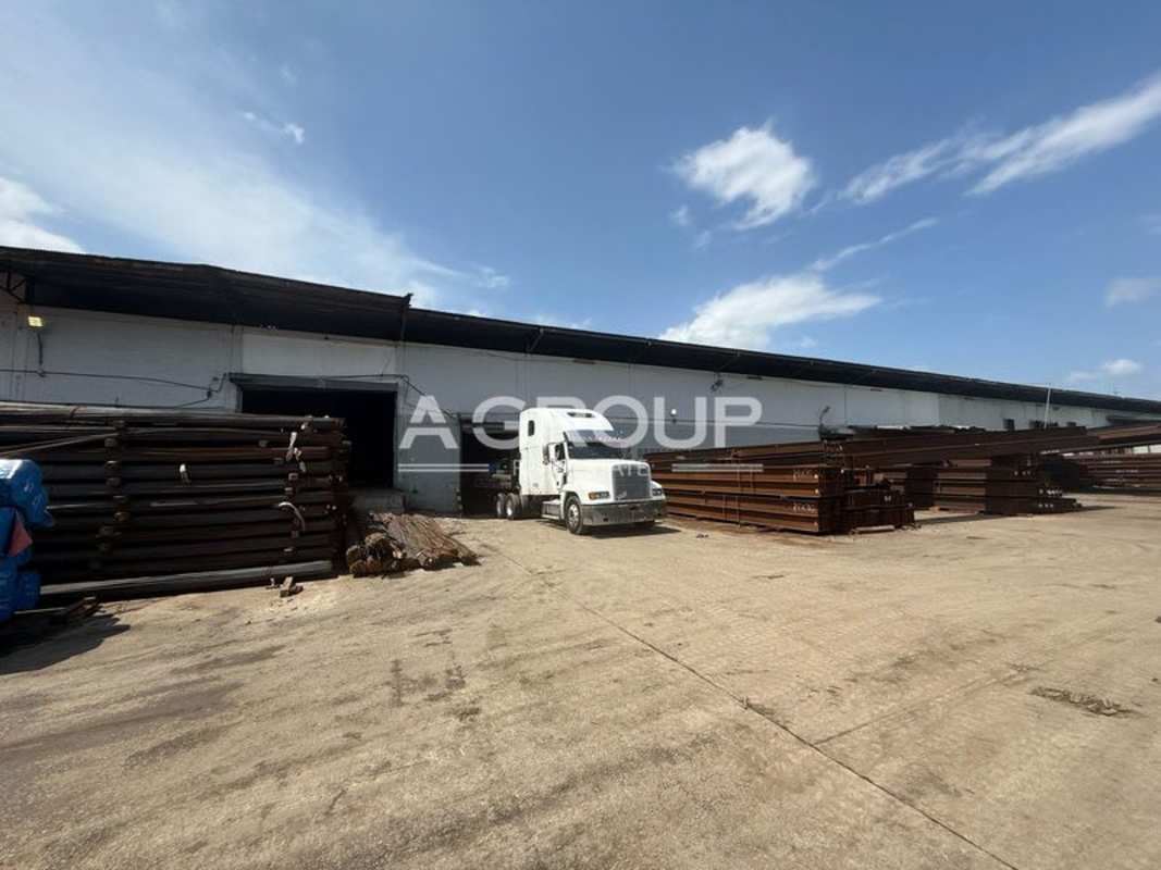 Large yard with containers, semi-truck and warehouse building at Panama City Juan Díaz