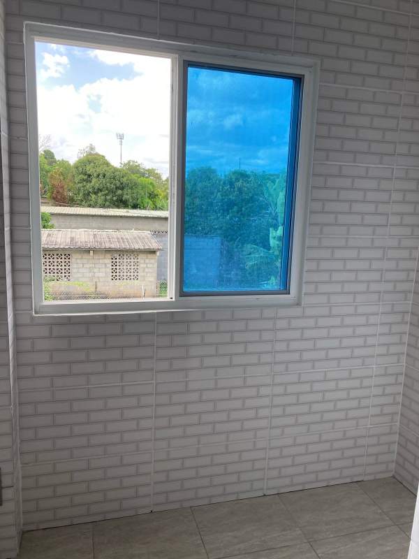 Kitchen with granite countertop, tiled wall and window PH Villa Lua Tocumen Panama