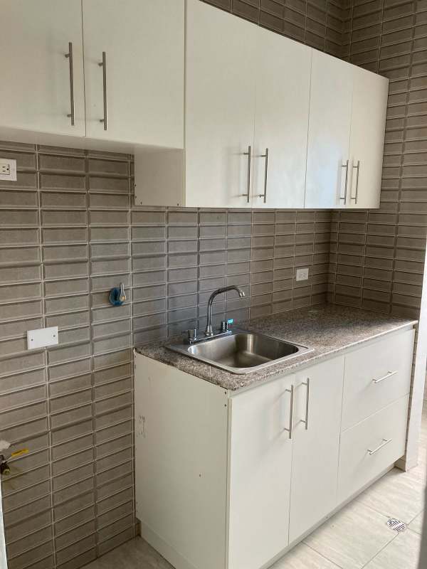 Granite countertop and gray tile backsplash in new condo Villa Lua Tocumen