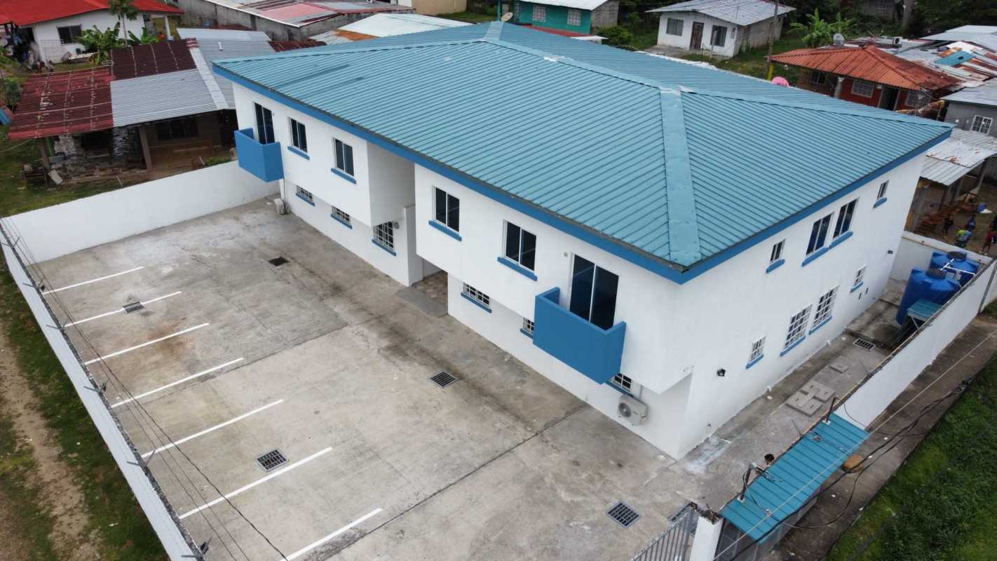 Aerial showing PH Villa Lua two story apartments with blue roofs and parking