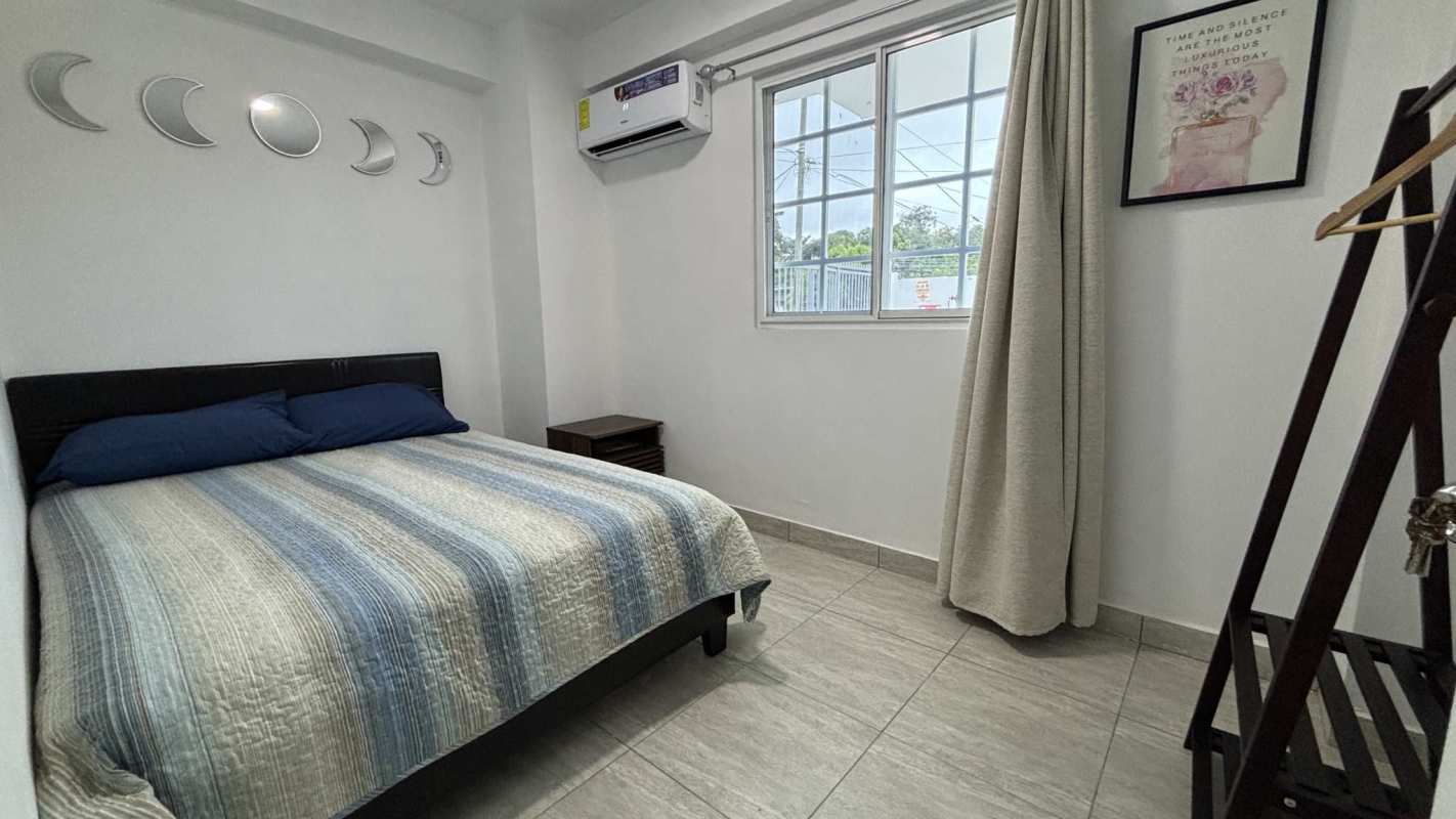 Bedroom with AC, large window, tile flooring in PH Villa Lua Tocumen furnished apartment Panama