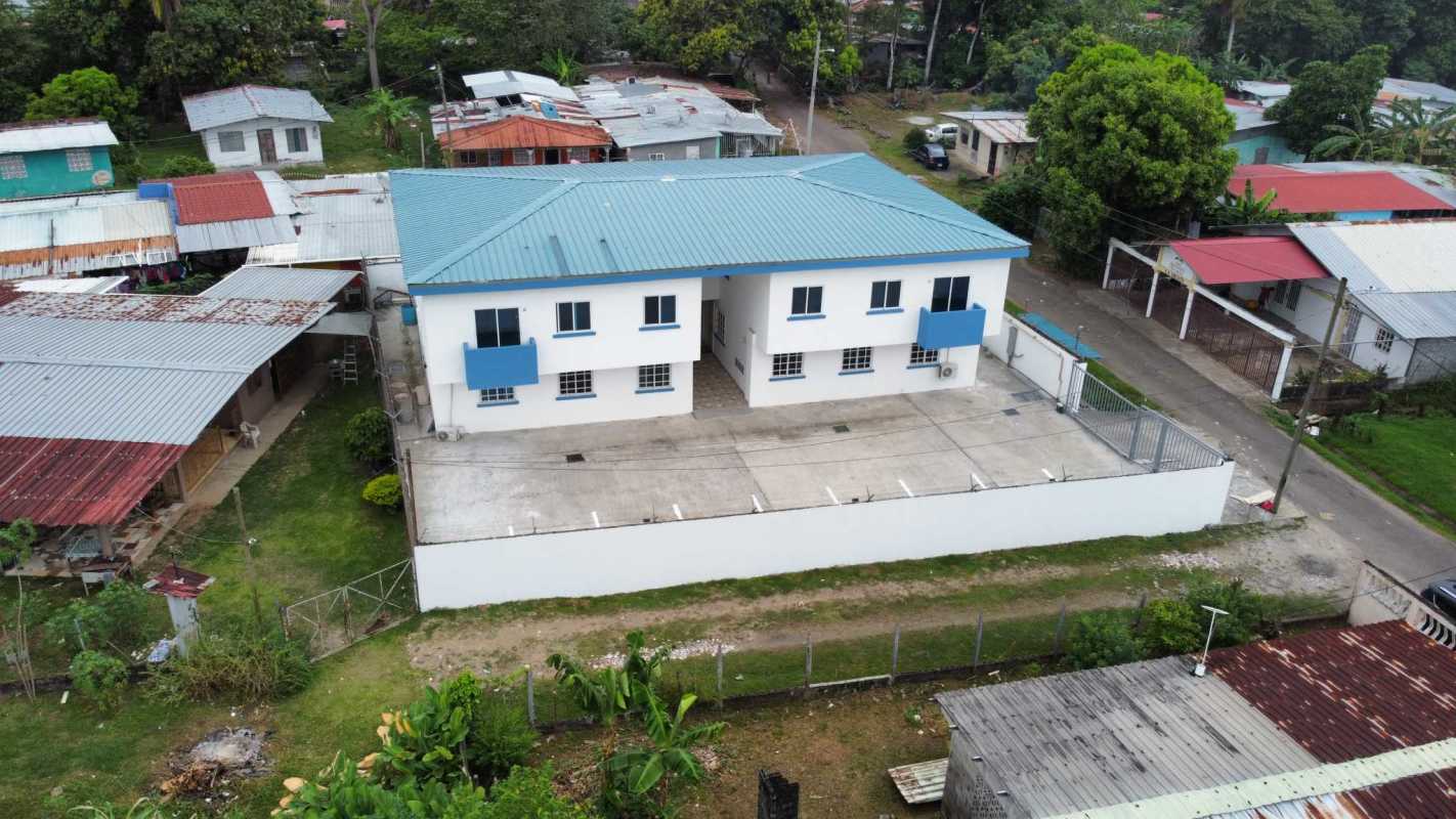 Aerial photo PH Villa Lua apartment complex with blue roofs, secure fence in Tocumen Panama