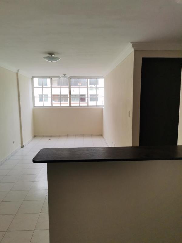 Minimalist living room with window and tile floors open to kitchen in Campo Limberg Don Bosco Panama