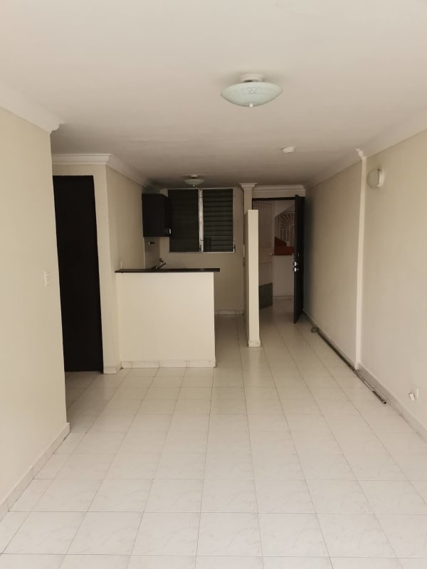 Minimalist kitchen with open layout and bright living room Campo Limberg apartment Panama City