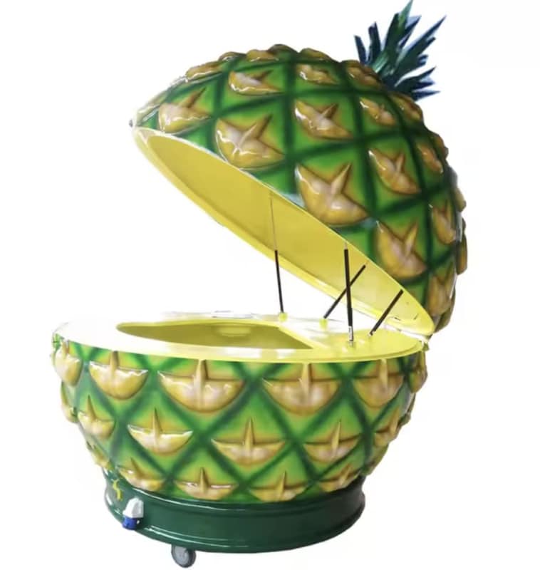 Novelty pineapple-shaped cocktail bar mobile kiosk with vibrant design on Punta Pacífica beachwalk Panama