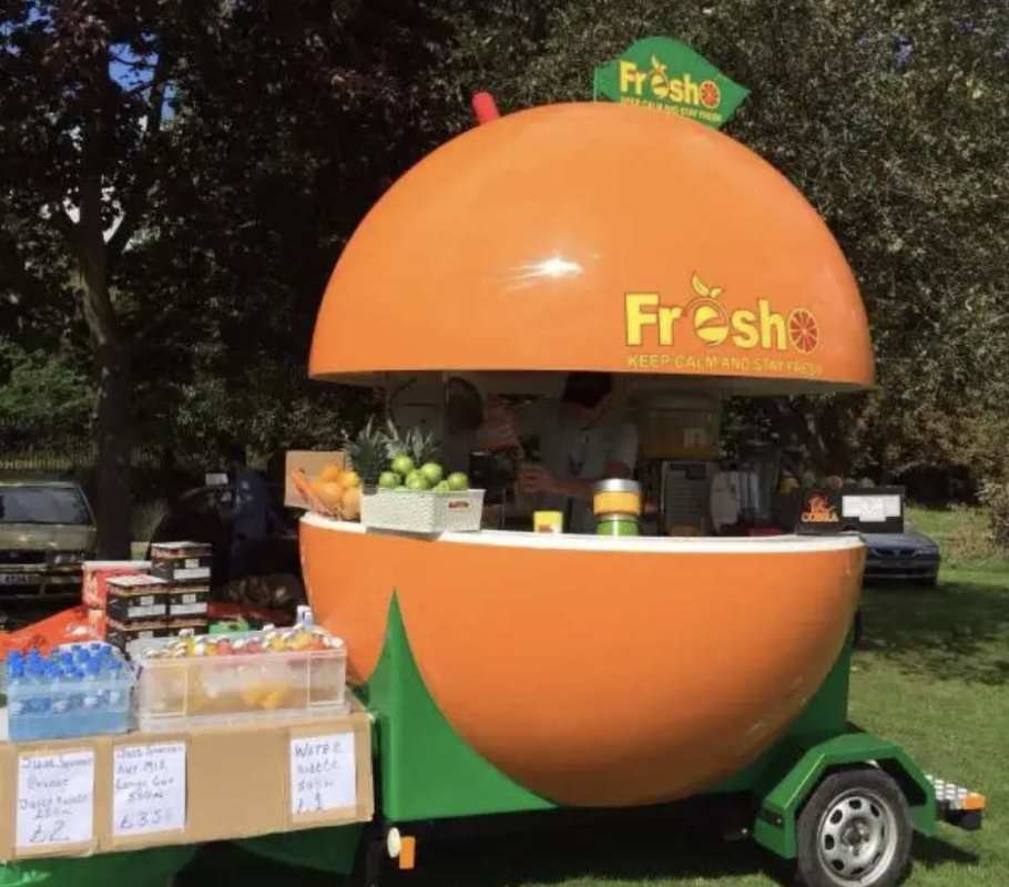 Pineapple-shaped cocktail kiosk on Panama City beach with seaside boardwalk setting