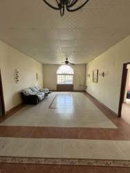 Traditional living room with arches, tile floors, ceiling fan in ranch style home Penonomé