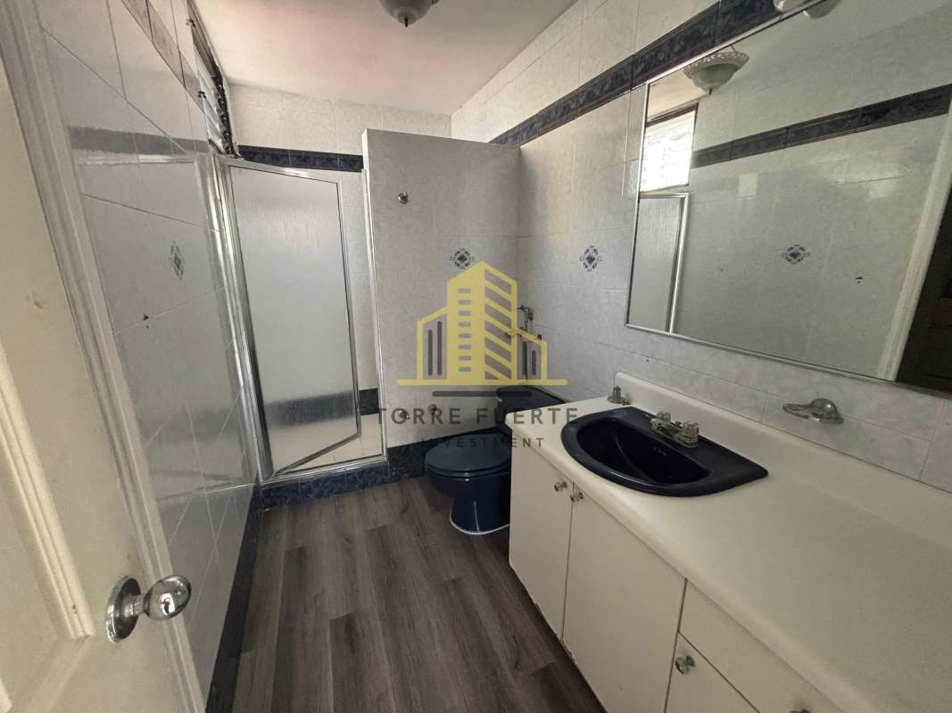 Minimalist bathroom with walk-in shower and white tiles Obarrio Panama