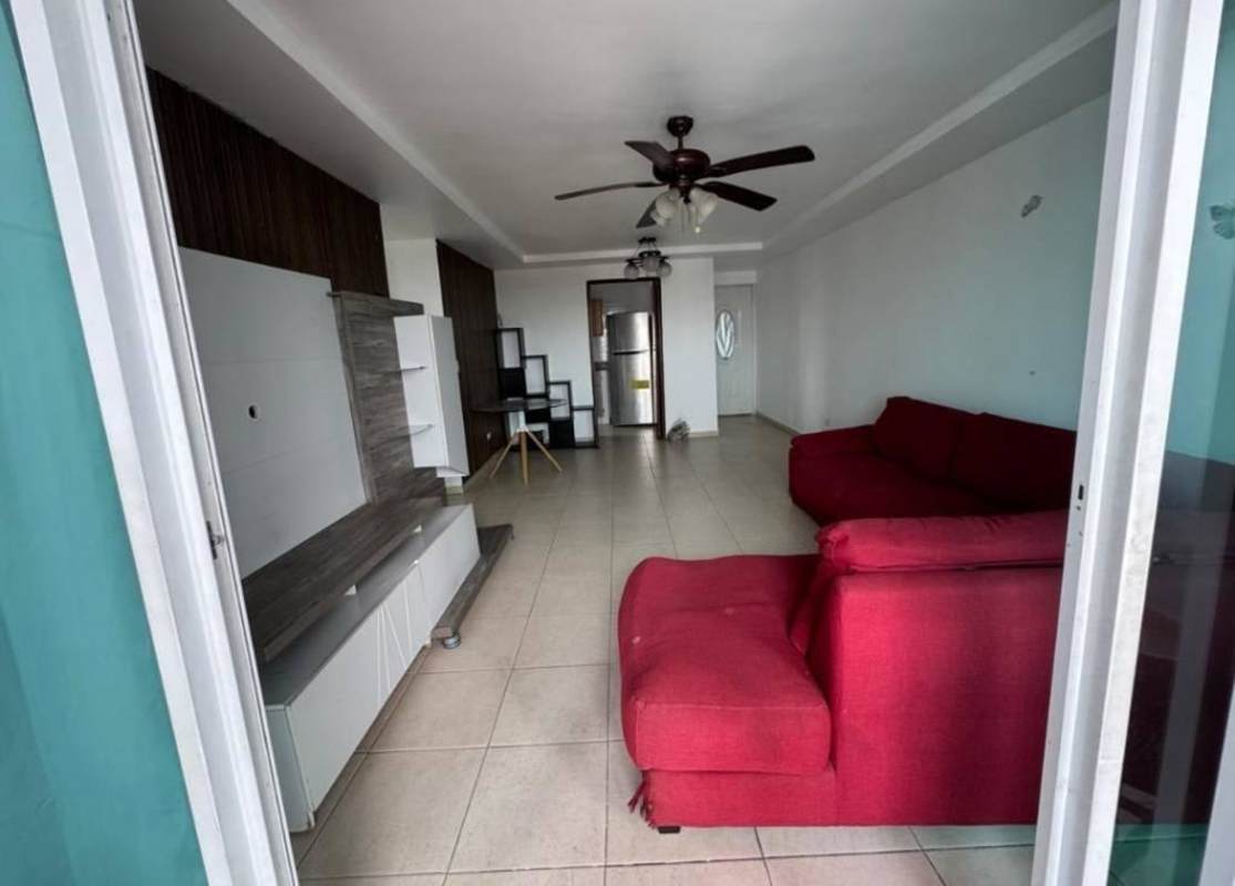 Open living room with red sectional sofa and entertainment unit at PH Golden Boulevard Panama City