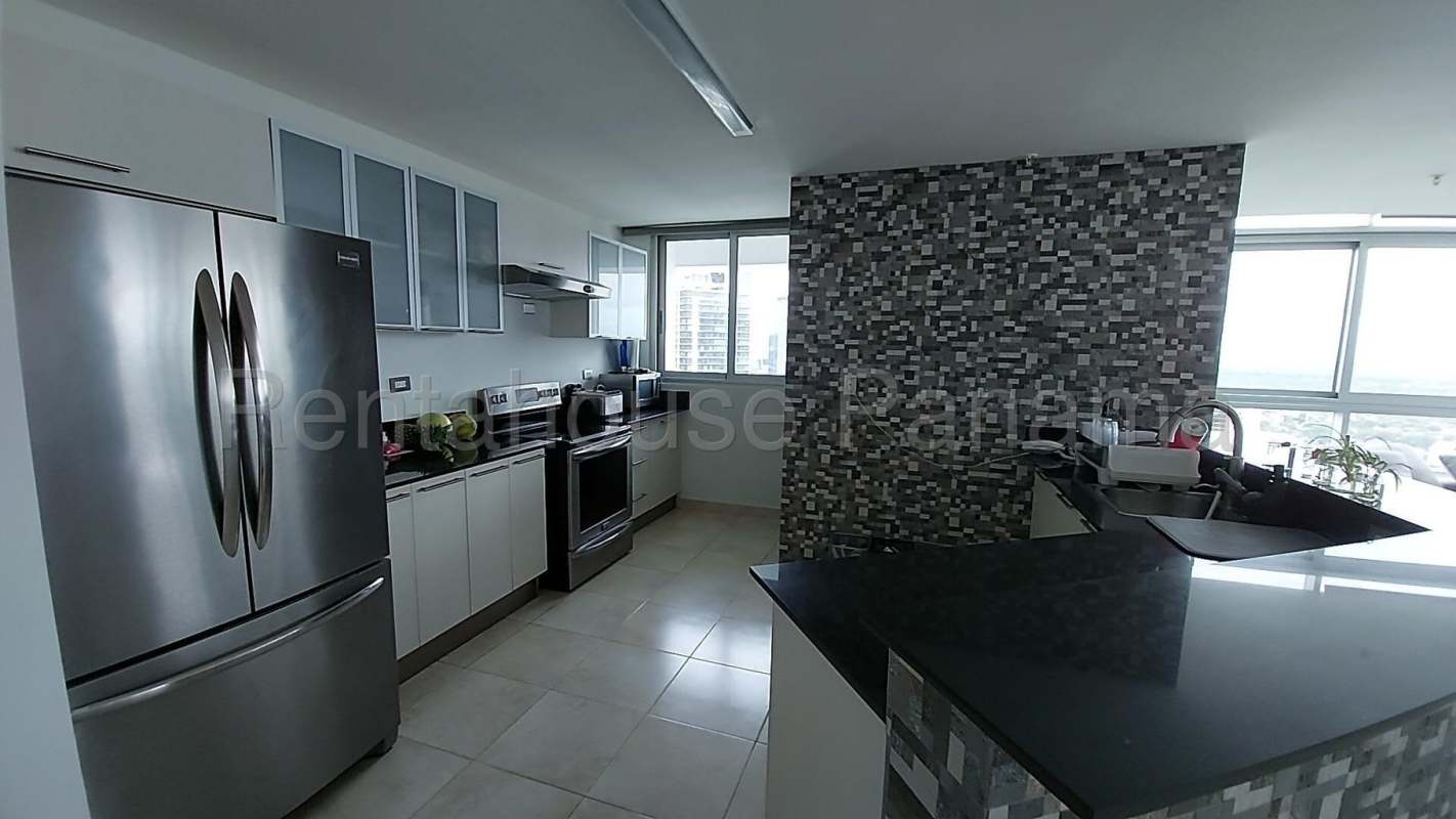 Kitchen with granite countertops and stainless steel appliances in PH Riverside Costa del Este Panama City