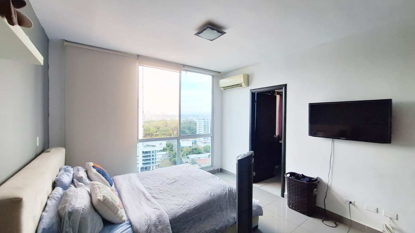 Modern bedroom with city skyline views and split AC unit in PH Quartier 74 San Francisco Panama