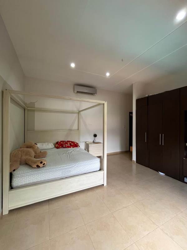 Elegant foyer featuring curved staircase, marble flooring, tall ceiling in luxury home in Costa del Este Panama