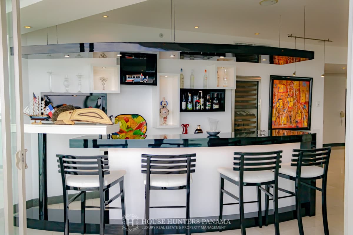 Curved glass balcony overlooking Pacific Ocean and Panama skyline in luxury penthouse The Ocean Club JW Marriott