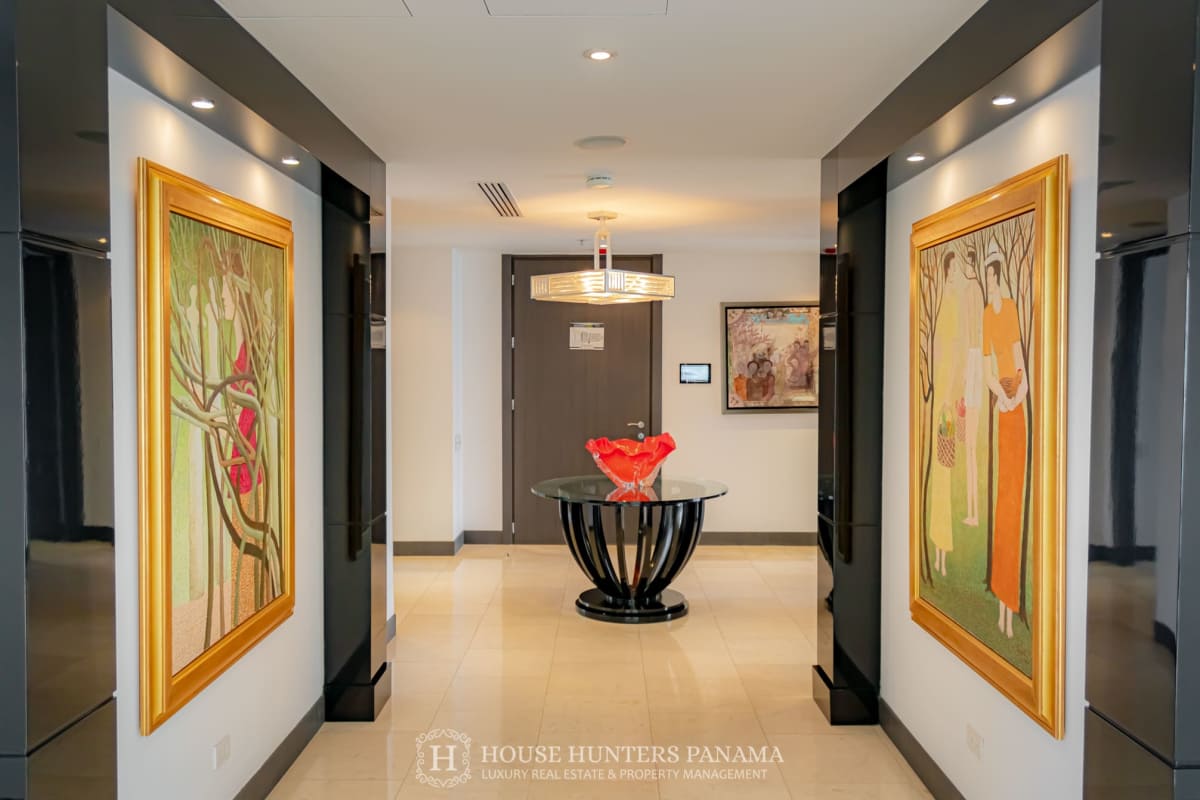 Modern entry hallway with large paintings and stylish lighting at The Ocean Club Punta Pacifica Penthouse
