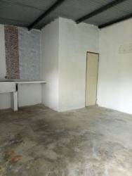 Basic bathroom with white toilet teal wall unfinished shower La Espiga Panama