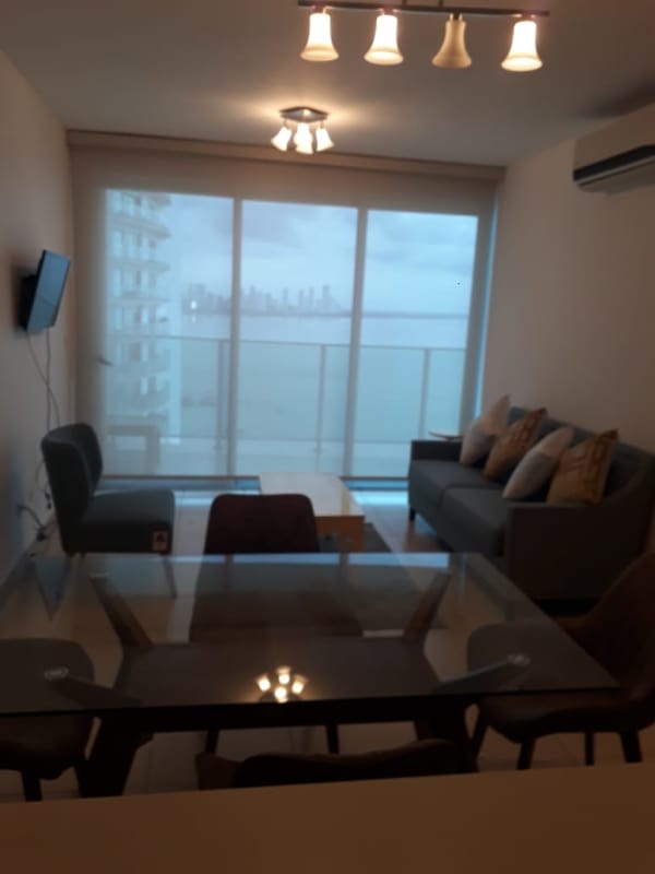Living area with panoramic glass doors overlooking Pacific Ocean Panama City