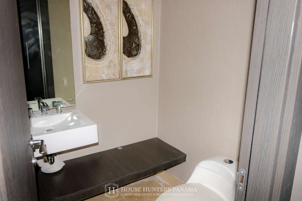 Elegant guest bathroom with marble counters at The Ocean Club Panama