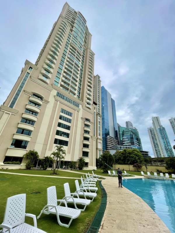 Open plan living room with marble floors, balcony access and ocean views in PH Ocean Two