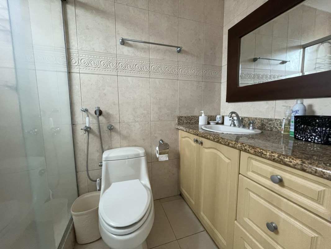 Modern bathroom with granite countertop and glass shower in PH Ocean Two Panama City