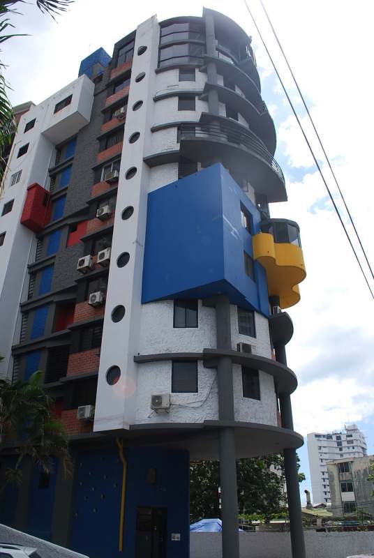 Boutique residential building exterior with colorful volume design and round windows in Coco del Mar Panama