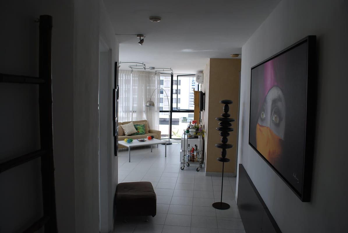 Modern living dining space with large windows overlooking city skyline PH Coco del Mar Panama