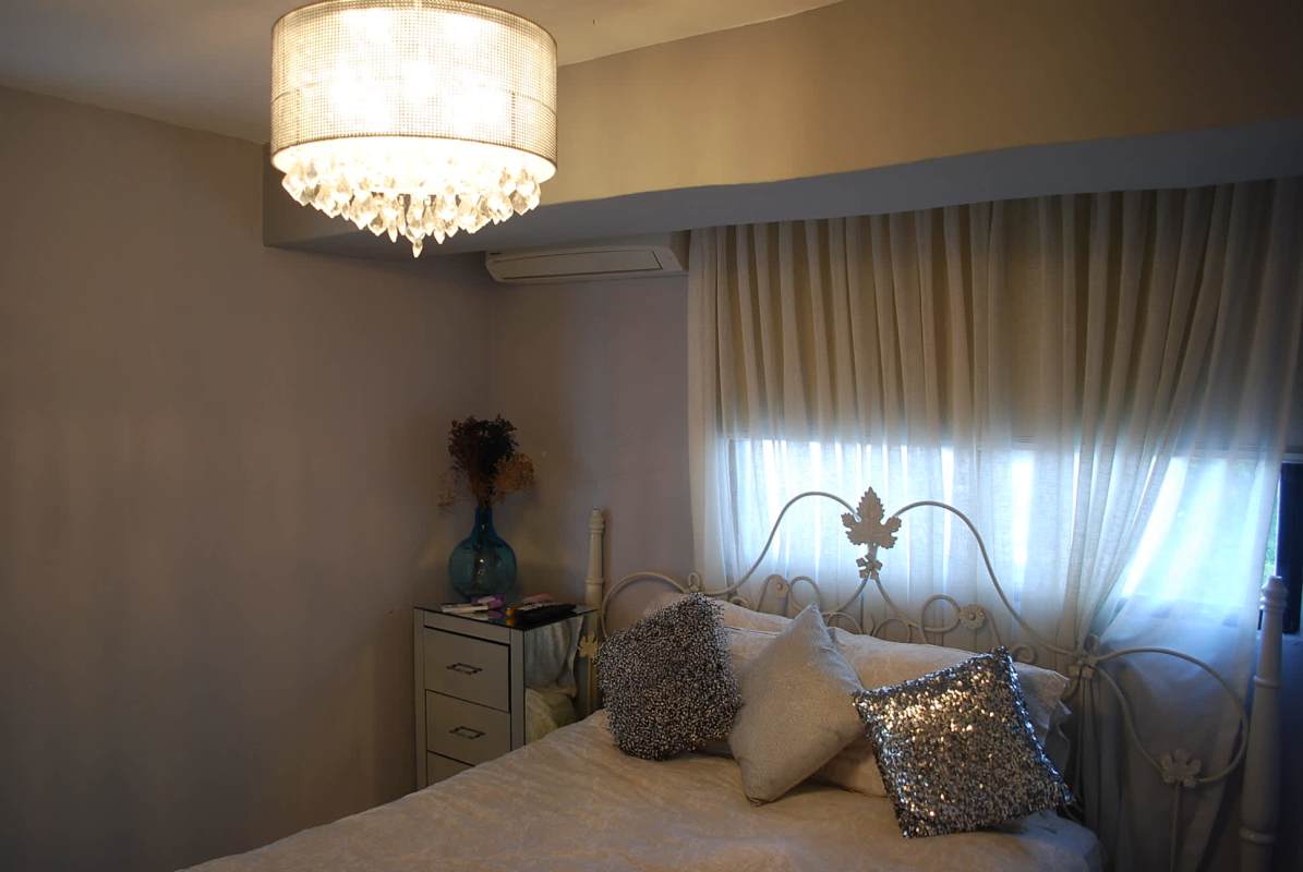 Elegant bedroom design with chic chandelier and large window PH Coco del Mar Panama