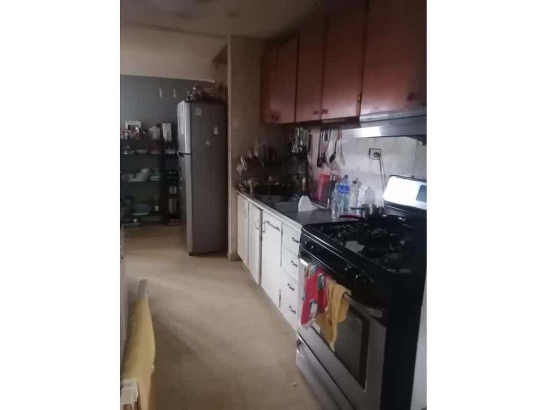 Kitchen with refrigerator stove wooden cabinets ceramic tile Chanis Panama