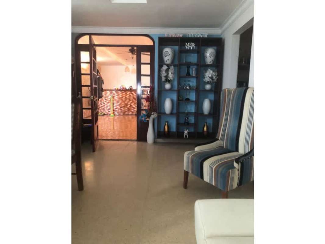 Living room blue accent shelves glass door armchairs at Chanis Panama