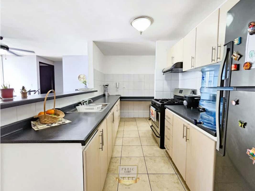 Open kitchen with cabinetry, stove, and appliances in PH Rim Tower Panama