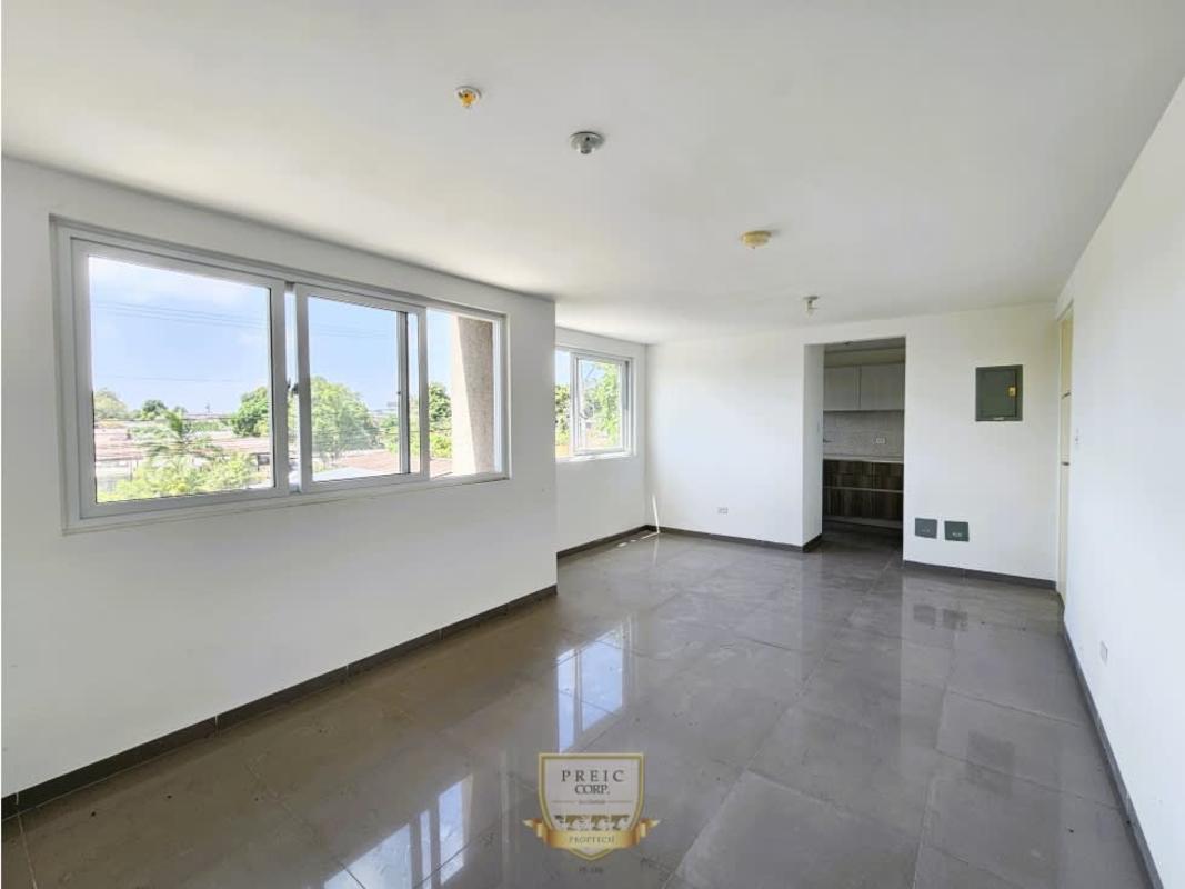 Unfurnished open living room with kitchen and tile floors Pedregal Panama