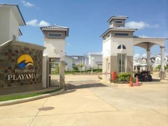 Contemporary Mediterranean style two-story house with tile roof, balcony, covered parking in Playamar Playa Dorada Vacamonte