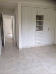 Unfurnished upstairs bedroom built-in white wardrobe tiled floor Playamar Playa Dorada Vacamonte