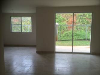 Living dining empty interior space sliding door garden view tiled floors Playamar Panama