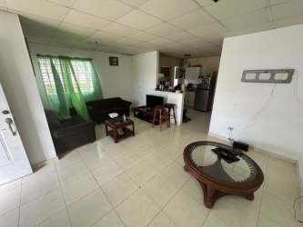 Living room area with sofa set, tiled floor, open kitchen in Quintas del Pacífico La Chorrera Panama