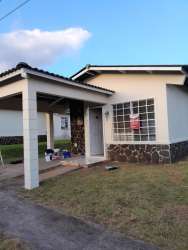 Single-story house exterior with porch, glass block window in Quintas del Pacífico Puerto Caimito Panama