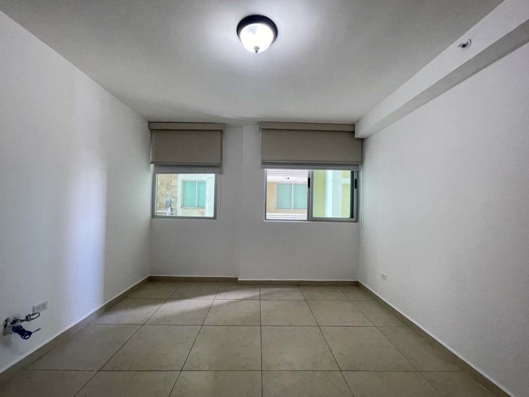 Master bedroom with built-in closet, large window with ocean skyline views, PH Majestic Panama