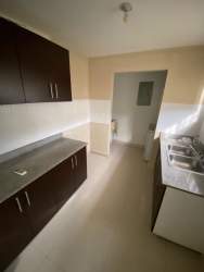 Contemporary kitchen with dark cabinets and stainless sink in rental house Panama