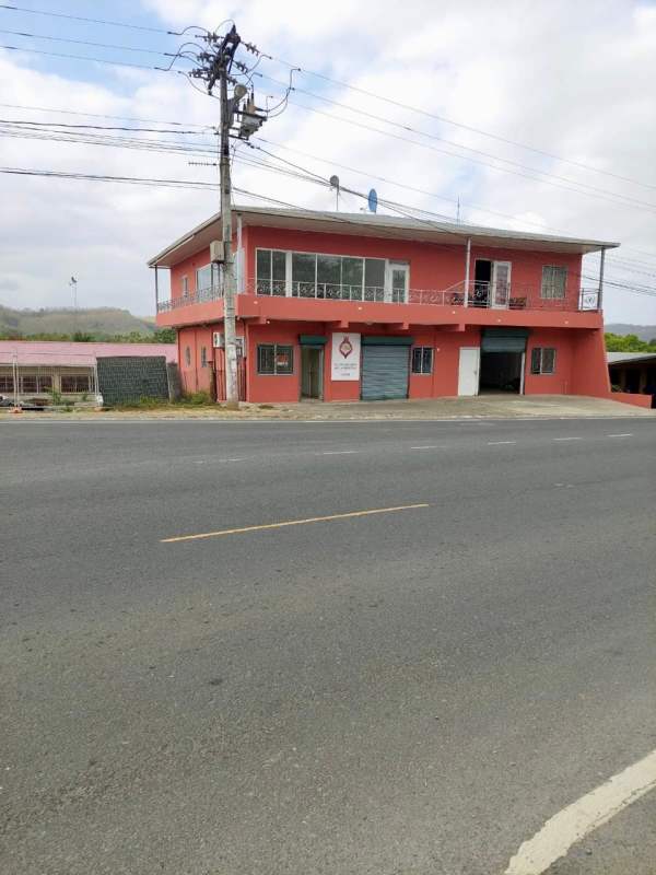 Facade of two-story building with balconies and garage door shops Canita Panama